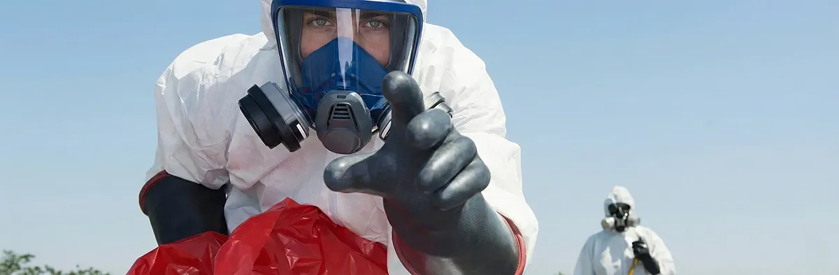 sewage clean up technician wearing protective gear handling biohazard materials in Nashville, TN